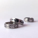 Spinner anxiety ring with engraved spinner. engraves include half moon, stars and small planets.
