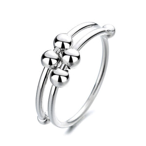 Double coiled silver wire ring with fidget rings moving on it